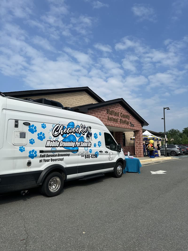 The Chewookie mobile grooming van parked at the kerb outside a brick building on a clear day